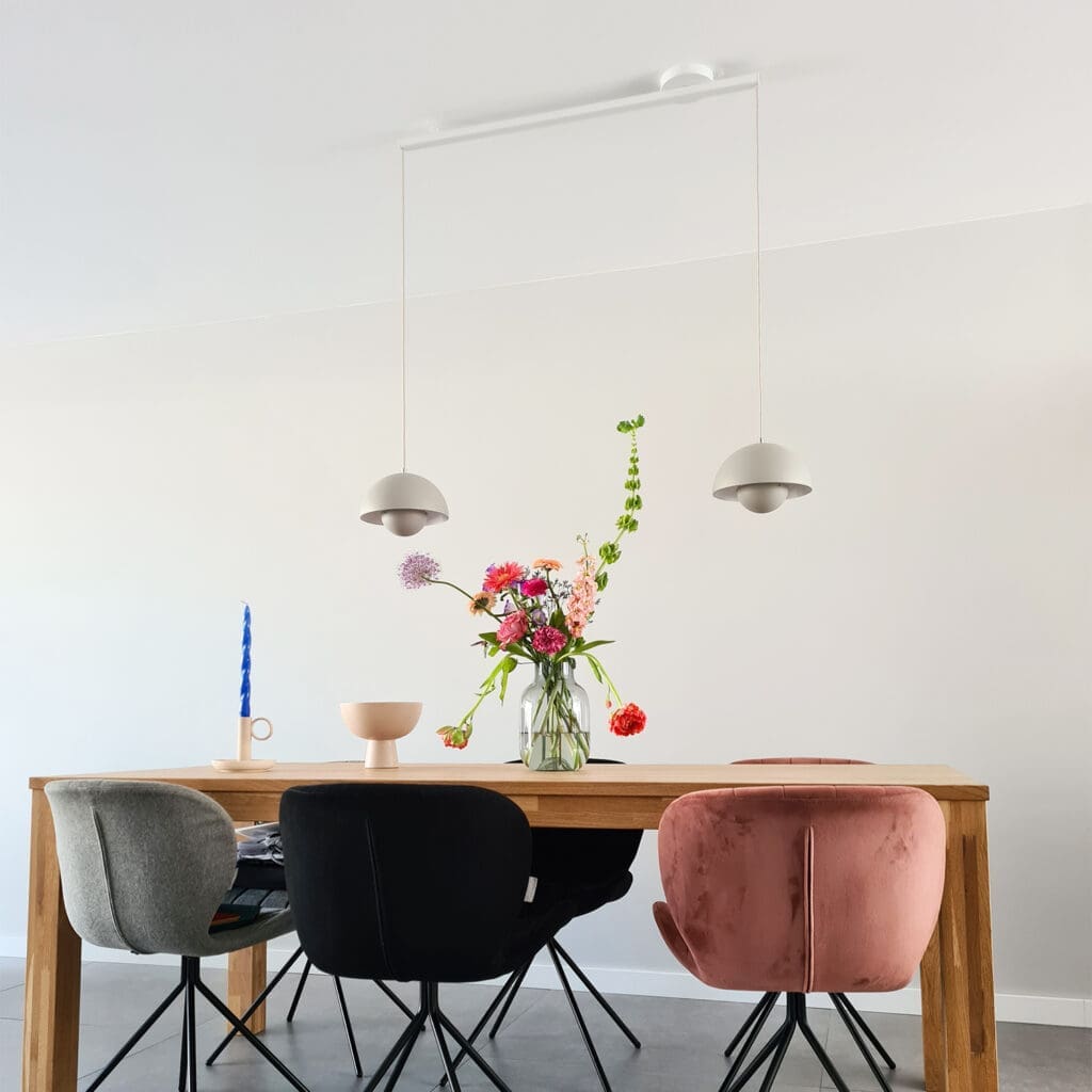 Lightswing Twin white in dining room with colourfull chairs